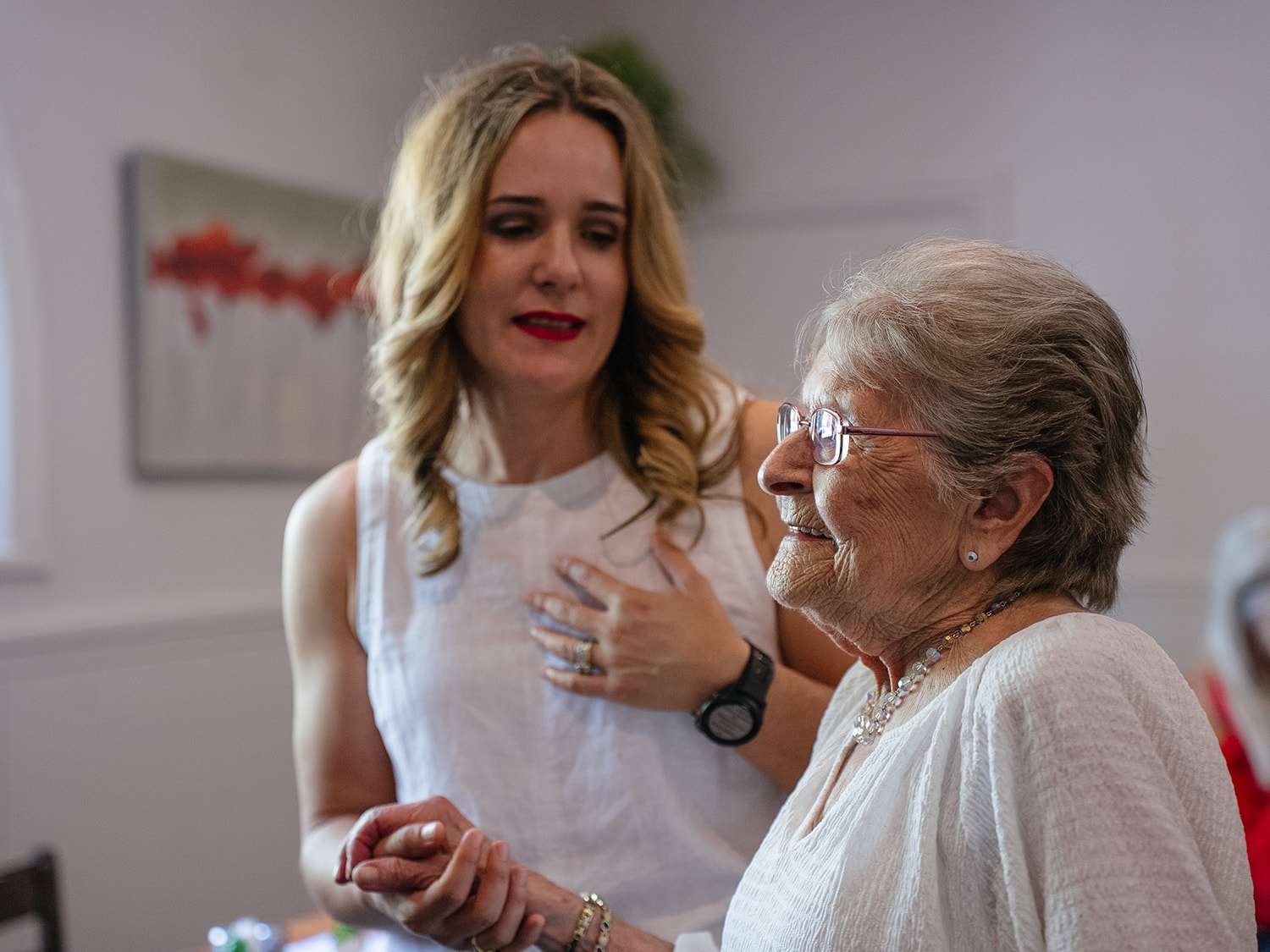 Care worker talking with an older woman in her home